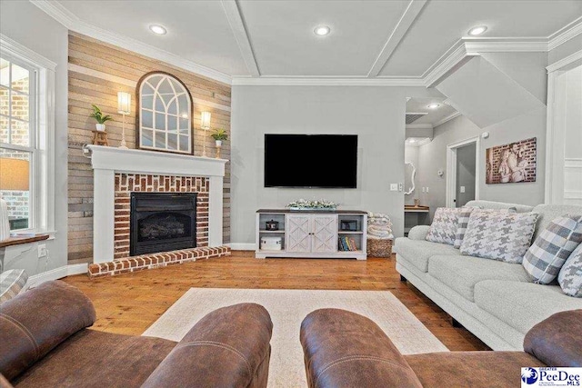 living room with recessed lighting, a brick fireplace, wood finished floors, and ornamental molding