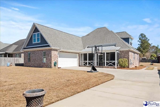 view of front facade featuring fence, driveway, roof with shingles, an attached garage, and brick siding