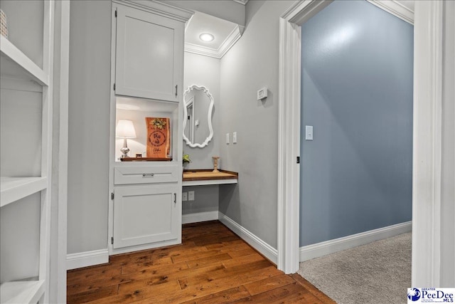 bathroom with crown molding, baseboards, and wood finished floors