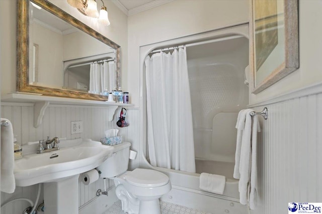 bathroom featuring a wainscoted wall, ornamental molding, toilet, and shower / tub combo