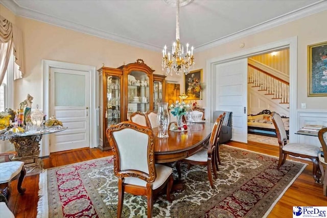 601 E Main St, Dillon, SC 29536 - dining area with a chandelier, ornamental molding, stairs, and wood finished floors