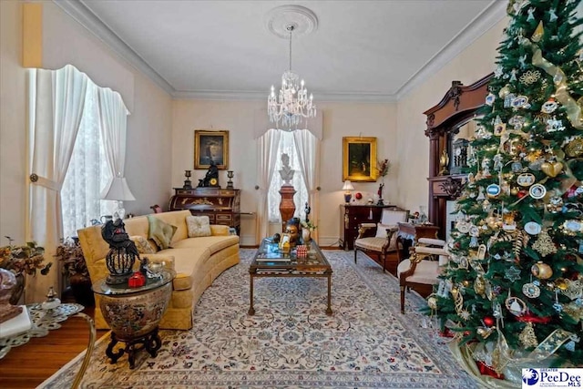 living area featuring a notable chandelier, ornamental molding, and wood finished floors
