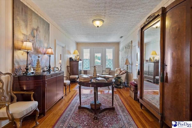 interior space featuring light wood-style flooring and a textured ceiling