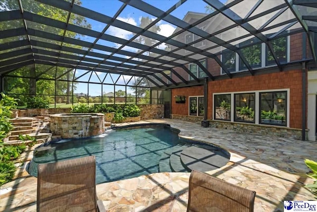 view of swimming pool featuring pool water feature, an in ground hot tub, a patio area, and a lanai