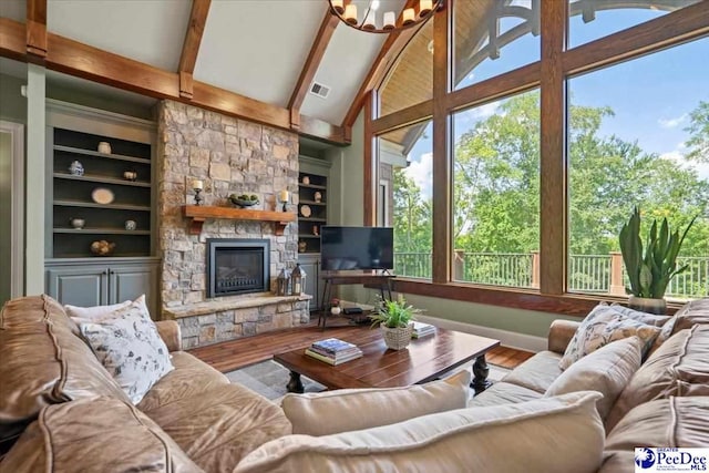 living room featuring built in shelves, a chandelier, hardwood / wood-style floors, and beamed ceiling