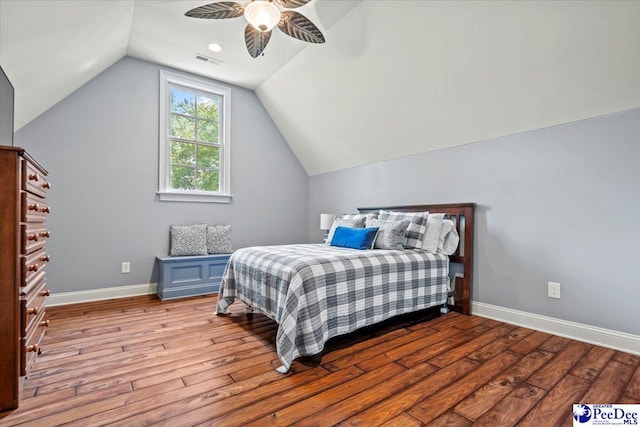 bedroom with ceiling fan, vaulted ceiling, and light hardwood / wood-style flooring