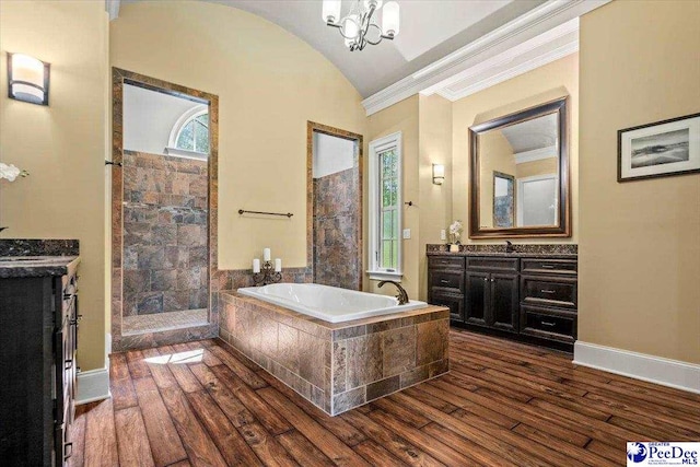 bathroom with vanity, wood-type flooring, separate shower and tub, and vaulted ceiling