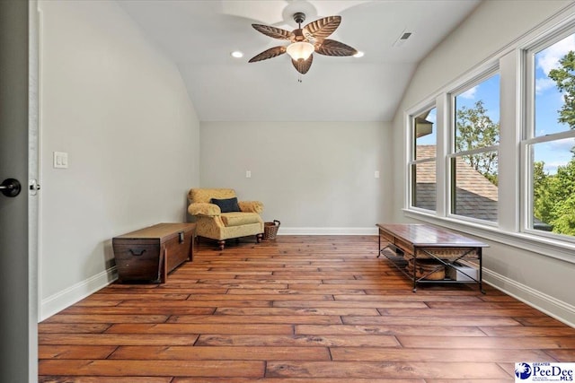 living area with lofted ceiling, ceiling fan, and light wood-type flooring