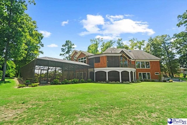 rear view of property with a lanai and a lawn