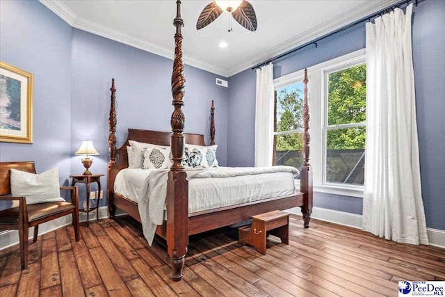 bedroom featuring hardwood / wood-style flooring, ornamental molding, and ceiling fan