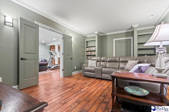 living room with ornamental molding, wood-type flooring, and built in features