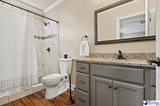 bathroom featuring hardwood / wood-style flooring, vanity, walk in shower, toilet, and crown molding