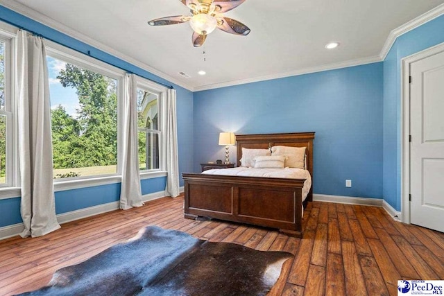 bedroom featuring crown molding, ceiling fan, and wood-type flooring