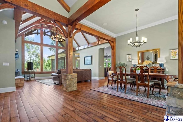 dining room featuring an inviting chandelier, a wealth of natural light, dark wood-type flooring, and high vaulted ceiling