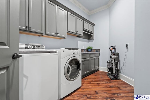 laundry area with cabinets, dark hardwood / wood-style floors, ornamental molding, and independent washer and dryer