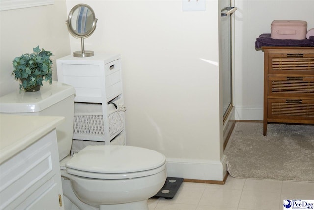 bathroom with baseboards, toilet, and a stall shower