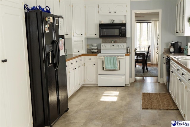 kitchen featuring black appliances and white cabinets