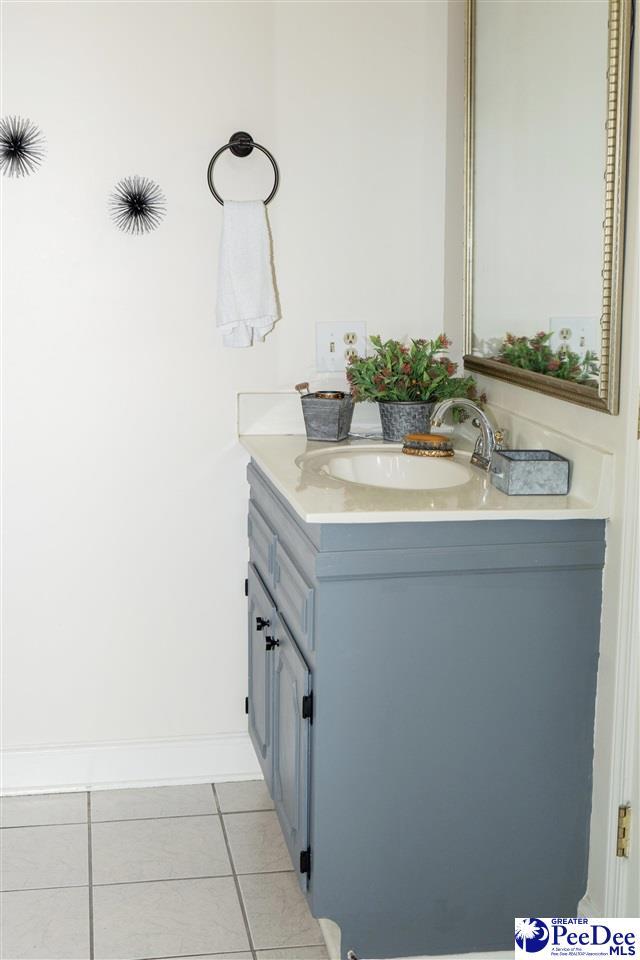 bathroom with tile patterned floors and vanity