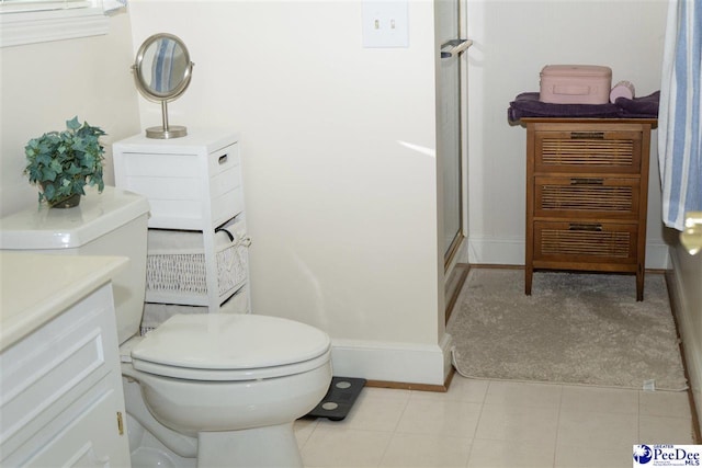 full bathroom featuring vanity, baseboards, a shower stall, and toilet