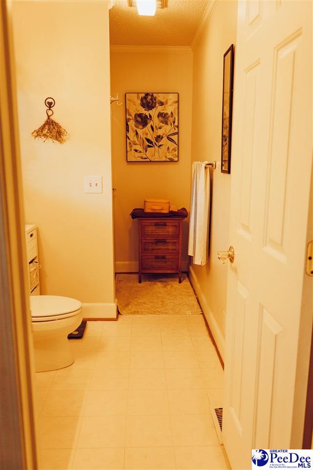 hall featuring baseboards and ornamental molding