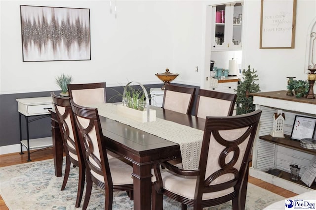 dining room featuring wood finished floors and baseboards