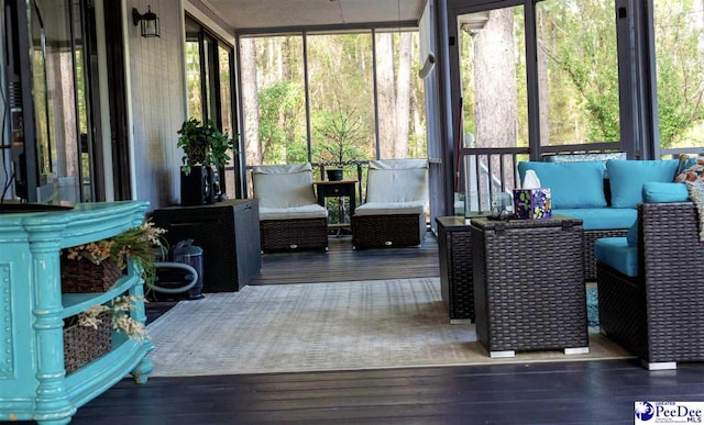sunroom featuring an outdoor hangout area
