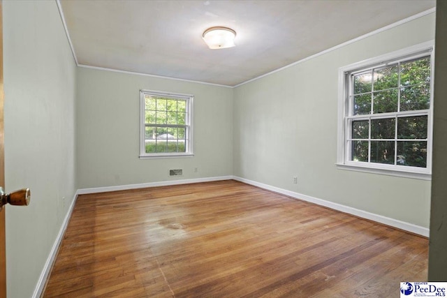1817 E Sandhurst Dr, Florence, SC 29505 - spare room featuring ornamental molding, wood finished floors, and baseboards