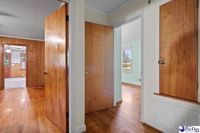 1817 E Sandhurst Dr, Florence, SC 29505 - hallway with wood finished floors, ornamental molding, healthy amount of natural light, and baseboards