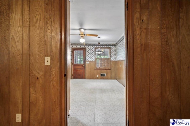 1817 E Sandhurst Dr, Florence, SC 29505 - empty room featuring wallpapered walls, light flooring, a ceiling fan, a wainscoted wall, and wooden walls