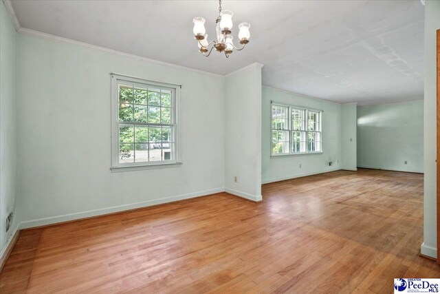 1817 E Sandhurst Dr, Florence, SC 29505 - spare room featuring a chandelier, light wood-style floors, baseboards, and ornamental molding