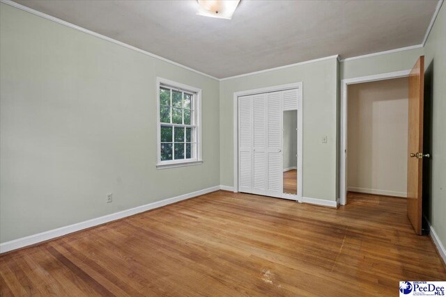 1817 E Sandhurst Dr, Florence, SC 29505 - unfurnished bedroom featuring crown molding, light wood-style floors, baseboards, and a closet