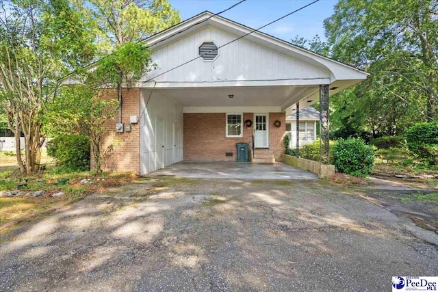 1817 E Sandhurst Dr, Florence, SC 29505 - view of front of house featuring brick siding, an attached carport, and asphalt driveway