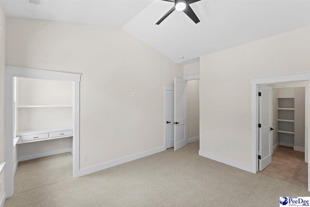 319 Railroad Ave, Florence, SC 29506 - unfurnished bedroom featuring light colored carpet, vaulted ceiling, baseboards, and a ceiling fan