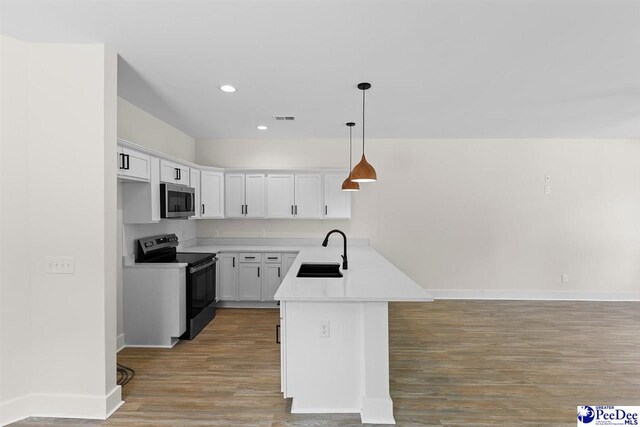319 Railroad Ave, Florence, SC 29506 - kitchen with electric stove, stainless steel microwave, a sink, a peninsula, and baseboards