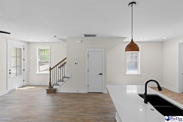 319 Railroad Ave, Florence, SC 29506 - kitchen with a sink, wood finished floors, baseboards, recessed lighting, and light countertops
