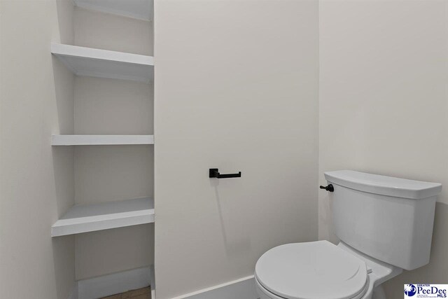 319 Railroad Ave, Florence, SC 29506 - bathroom featuring toilet and baseboards