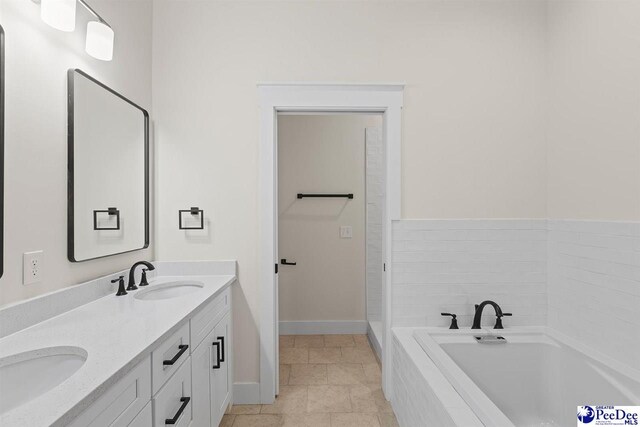 319 Railroad Ave, Florence, SC 29506 - bathroom with double vanity, a garden tub, baseboards, and tile patterned flooring