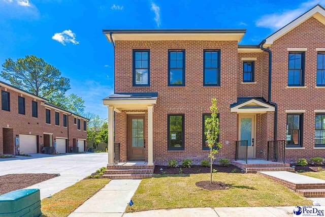319 Railroad Ave, Florence, SC 29506 - view of front facade featuring brick siding and a front lawn