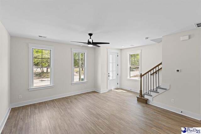 319 Railroad Ave, Florence, SC 29506 - unfurnished living room with wood finished floors, stairs, a ceiling fan, and baseboards