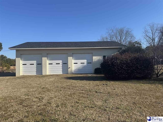 garage featuring a lawn