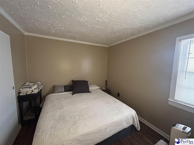 bedroom featuring hardwood / wood-style floors, ornamental molding, and a textured ceiling