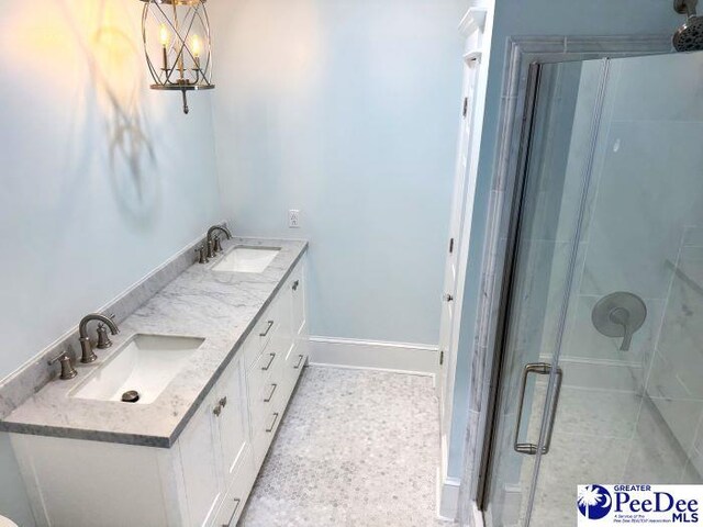 bathroom featuring vanity and a shower with door