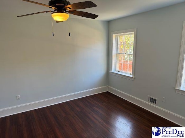 unfurnished room featuring ceiling fan and dark hardwood / wood-style flooring