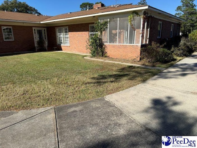 view of side of home featuring a lawn