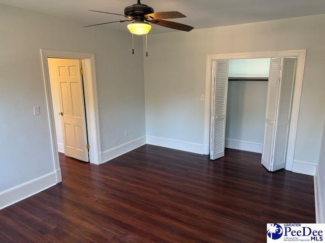 unfurnished bedroom featuring dark wood-type flooring, ceiling fan, and a closet