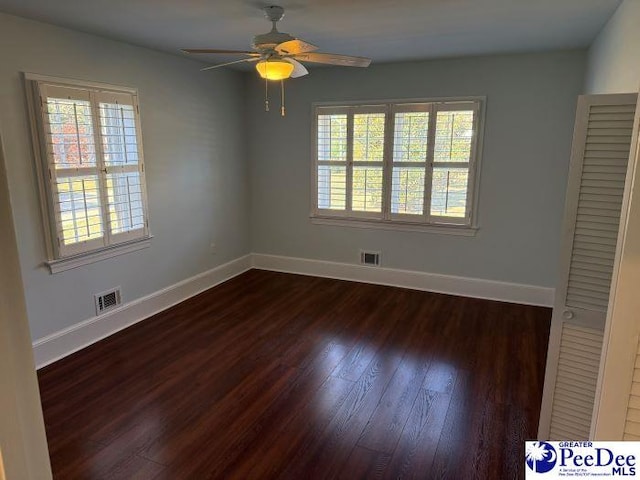 unfurnished room with ceiling fan, plenty of natural light, and dark hardwood / wood-style floors