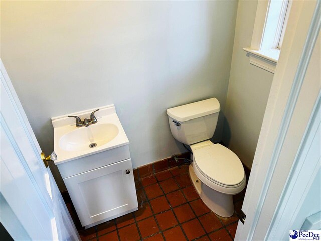 bathroom featuring vanity, tile patterned floors, and toilet