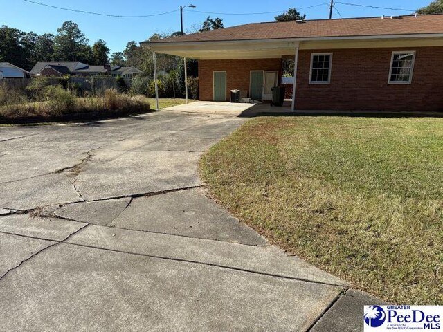 exterior space featuring a front yard and a carport