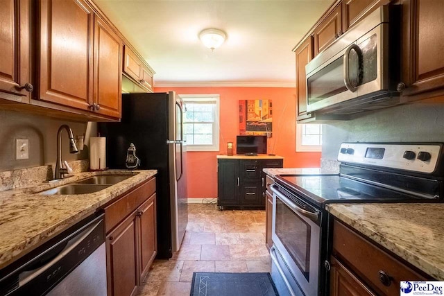 1510 N Rocky Way Dr, Florence, SC 29506 - kitchen with stainless steel appliances, a sink, baseboards, stone finish floor, and ornamental molding