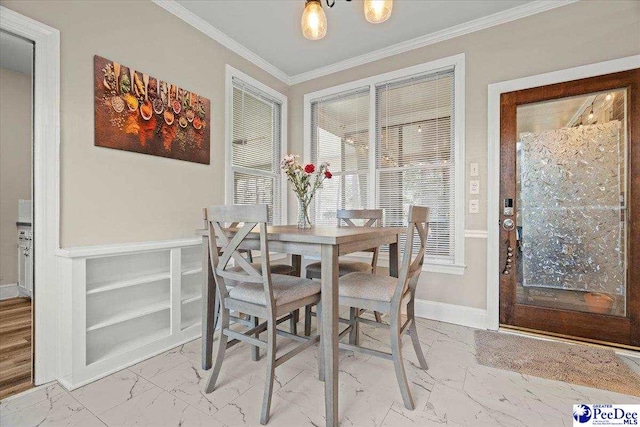 dining area featuring marble finish floor, crown molding, and baseboards